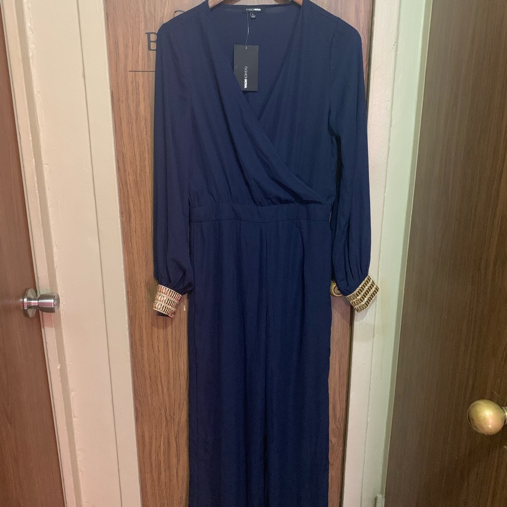 Fashion Nova size large navy blue jumpsuit with gold around the wrist.